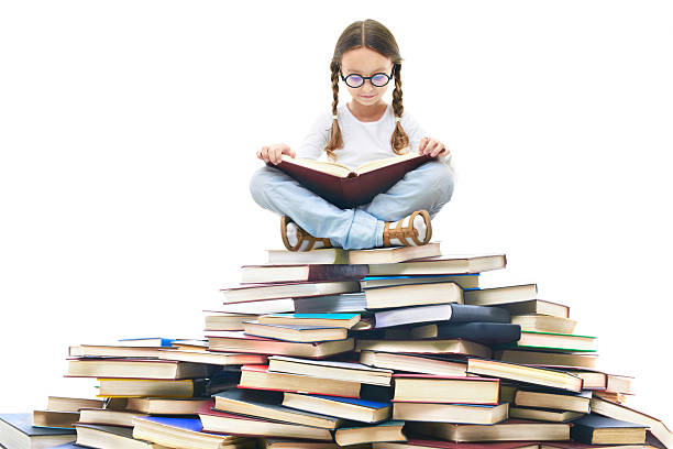 Portrait of cute girl with open book and looking at camera